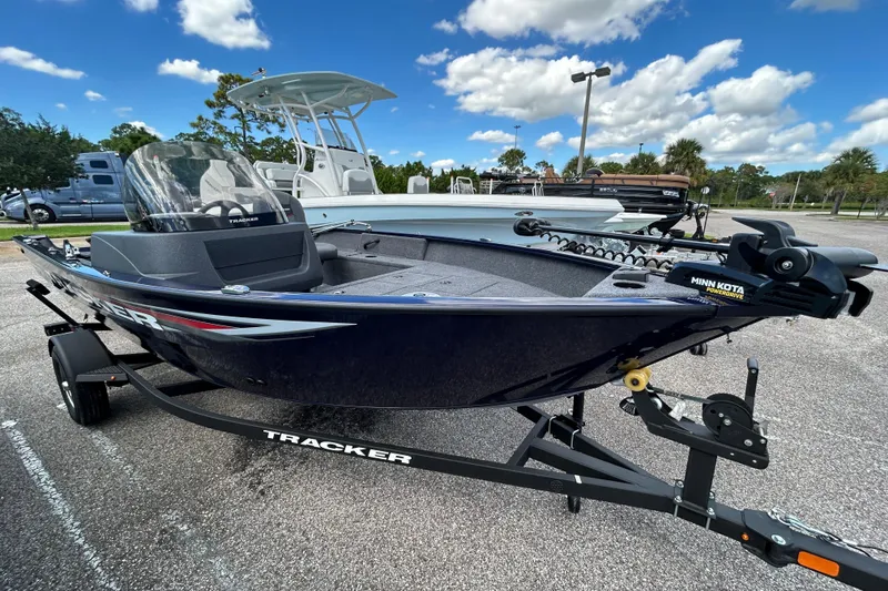 The Image of 2026 Tracker Pro Guide V-16 SC boat on trailer under blue sky. - 0