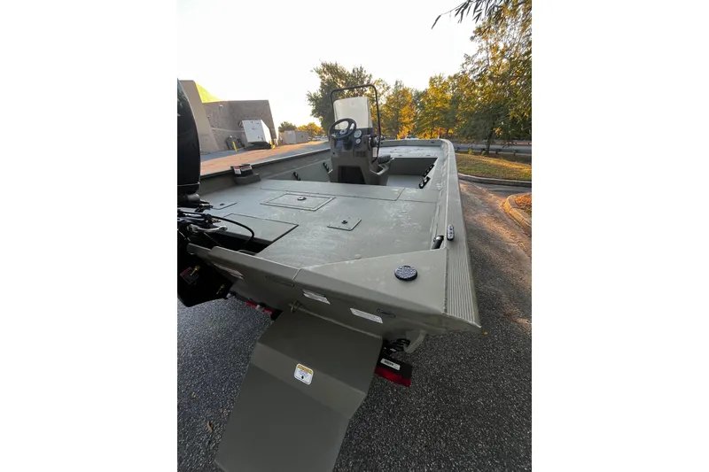 Slide: The Image of 2026 Tracker Grizzly 2072 CC boat on a trailer, parked outdoors in sunlight. - 4
