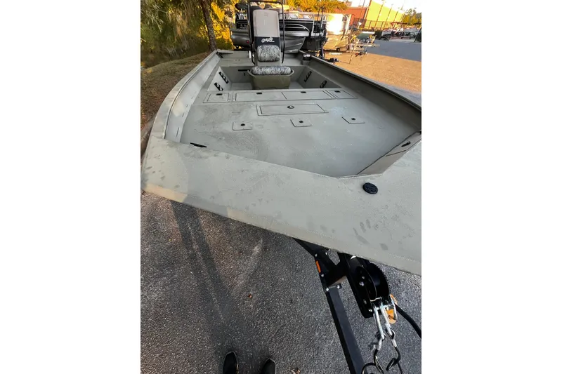 Slide: The Image of 2026 Tracker Grizzly 2072 CC boat on trailer, parked outdoors, showcasing spacious deck. - 6