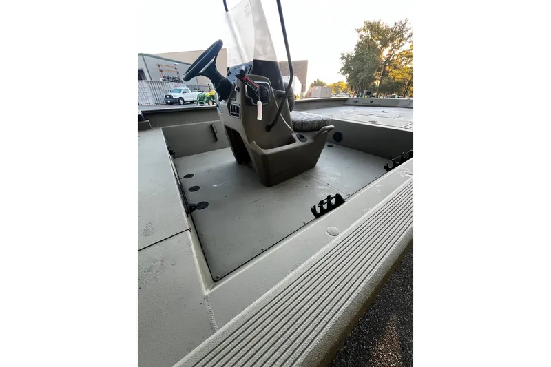 Slide: The Image of 2026 Tracker Grizzly 2072 CC boat interior with steering console and seating. - 7