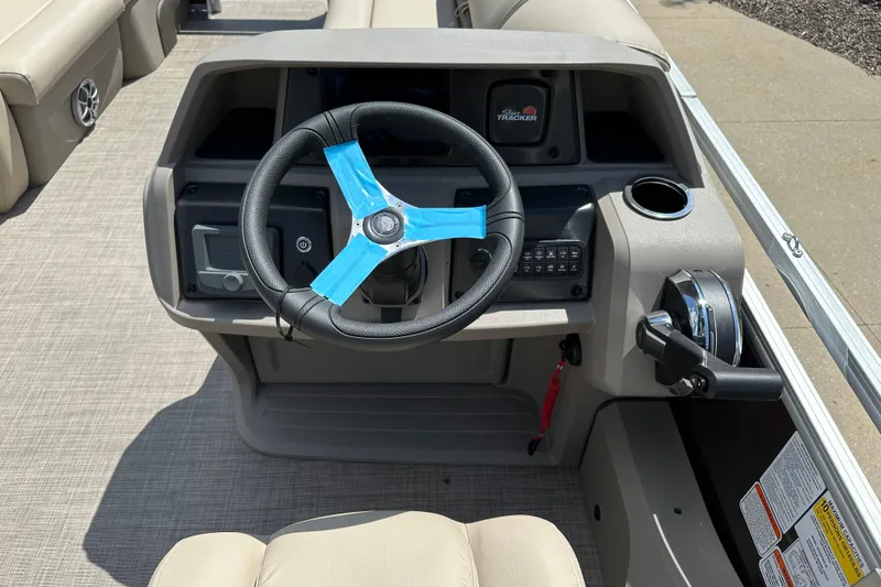 Slide: The Image of 2025 Sun Tracker SportFish 22 DLX steering console with modern controls and cup holder. - 6
