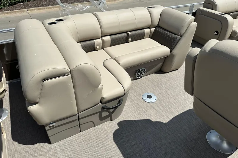 Slide: The Image of 2025 Sun Tracker SportFish 22 DLX boat interior with beige seating and cup holders. - 7