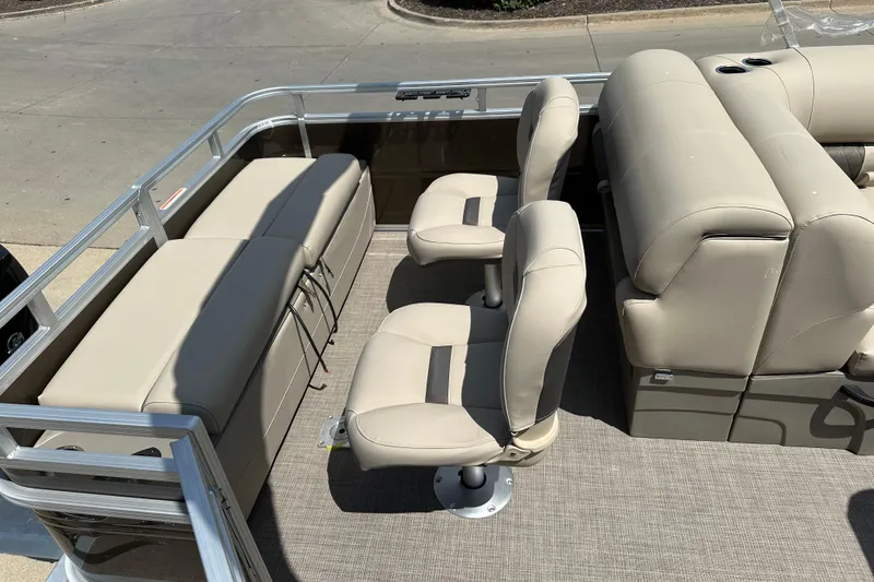 Slide: The Image of 2025 Sun Tracker SportFish 22 DLX interior with beige seating and spacious layout. - 9
