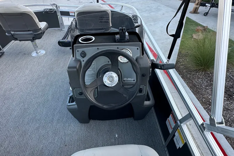 Slide: The Image of 2026 Sun Tracker Bass Buggy 16 XL Select steering console with seating and controls. - 25