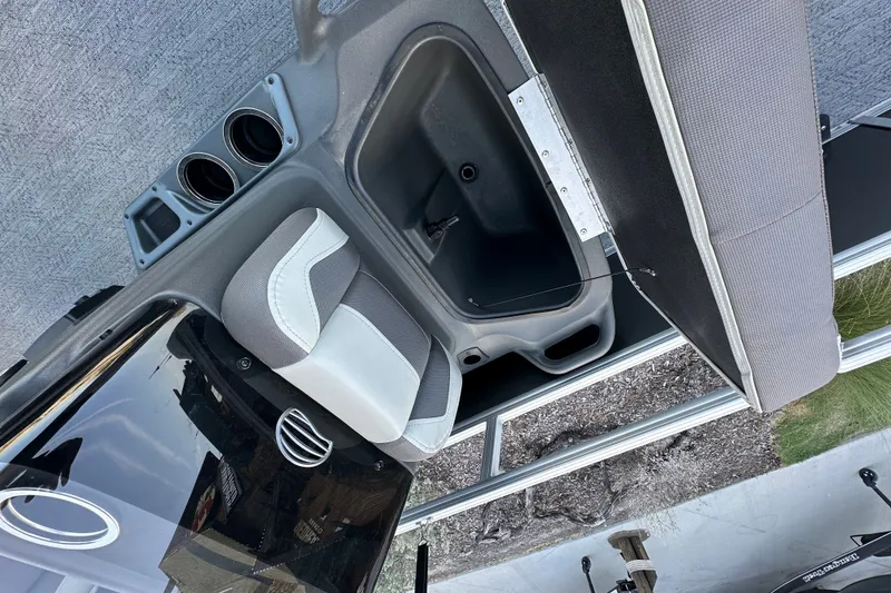 Slide: The Image of Interior view of 2026 Sun Tracker Bass Buggy 16 XL Select, featuring seating and cup holders. - 21