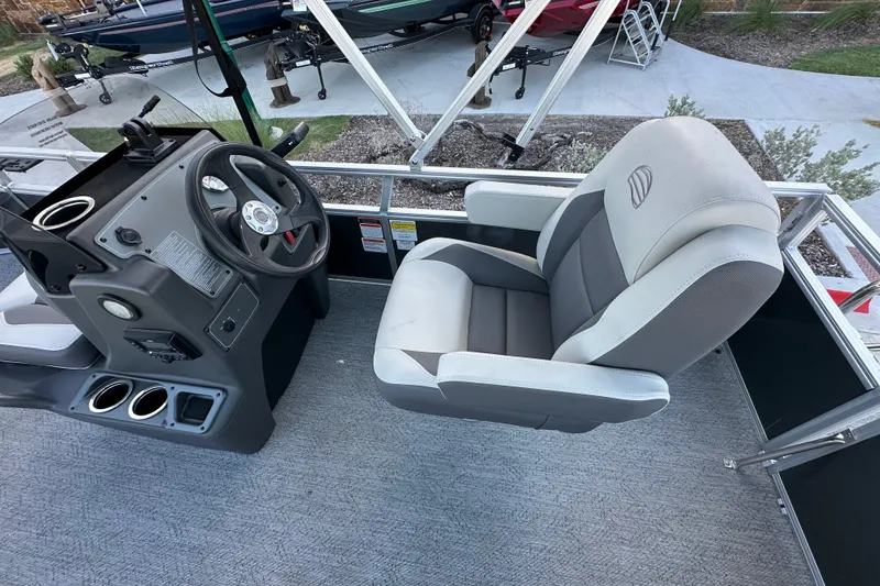 Slide: The Image of 2026 Sun Tracker Bass Buggy 16 XL Select boat interior with steering console and captain's chair. - 24