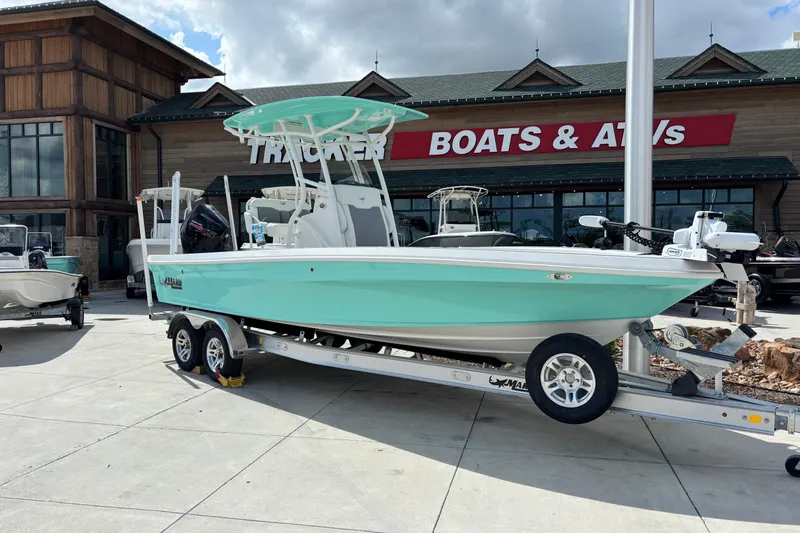 The Image of 2026 Mako 24 APEX boat on trailer outside Tracker Boats & ATVs store. - 0