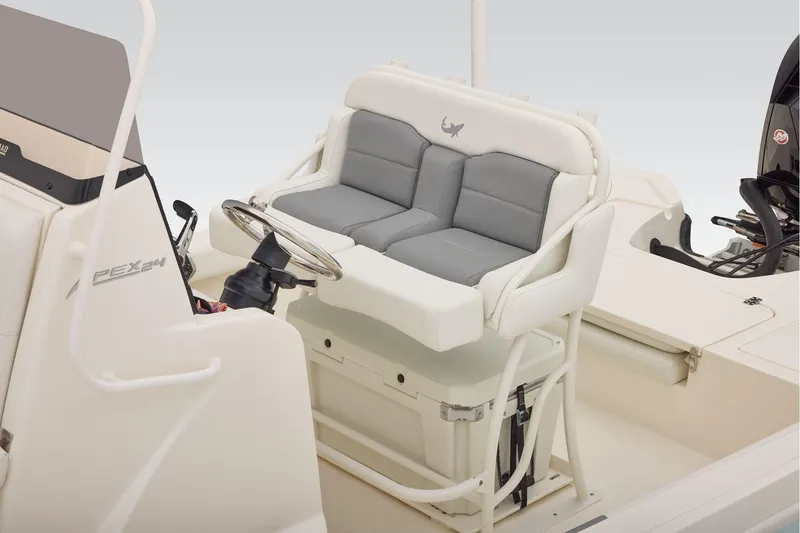 Slide: The Image of Helm of 2026 Mako 24 APEX boat with steering wheel and navigation display. - 35