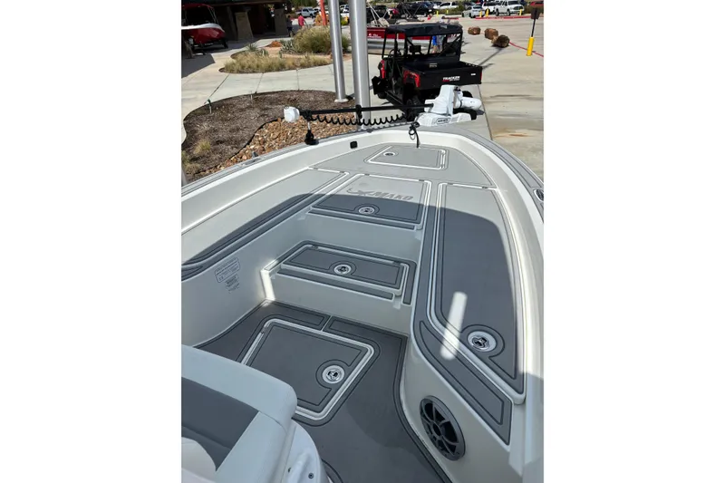 Slide: The Image of 2026 Mako 24 APEX boat deck with storage compartments and sleek design. - 5