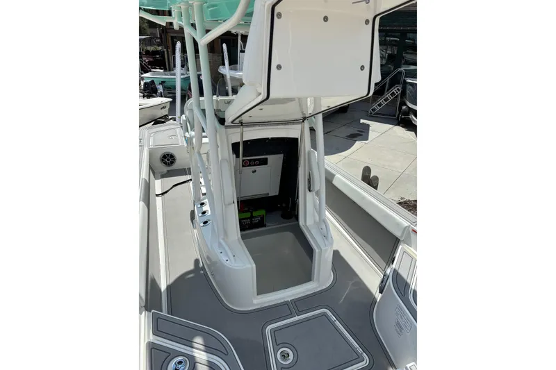 Slide: The Image of Open hatch on 2026 Mako 24 APEX boat revealing battery compartment. - 6