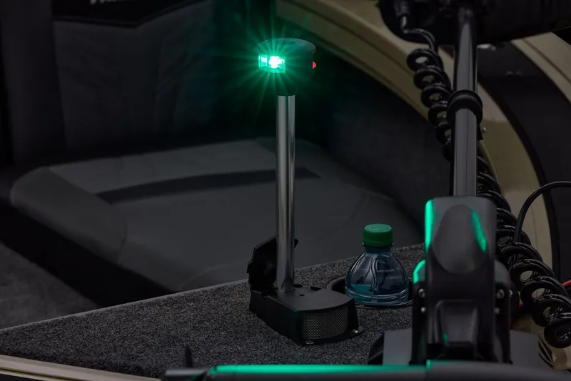 Slide: The Image of 2026 Tracker Targa V-19 Combo boat interior with green navigation light and water bottle. - 8