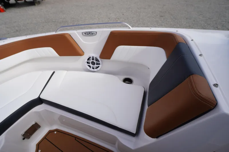 Slide: The Image of 2023 Chaparral 23 SSi OB boat interior with brown and white seating. - 10