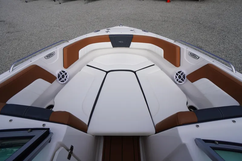 Slide: The Image of 2023 Chaparral 23 SSi OB boat interior with brown and white seating. - 11