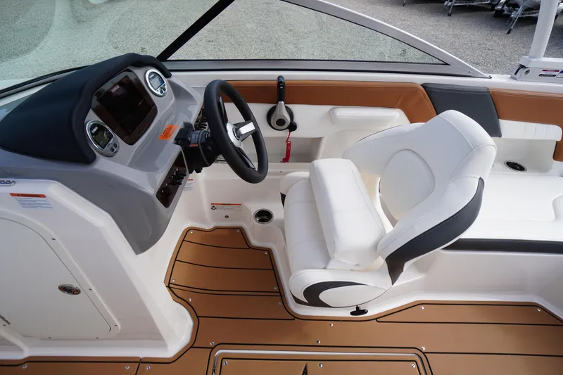 Slide: The Image of 2023 Chaparral 23 SSi OB boat interior with steering wheel and white seating. - 18