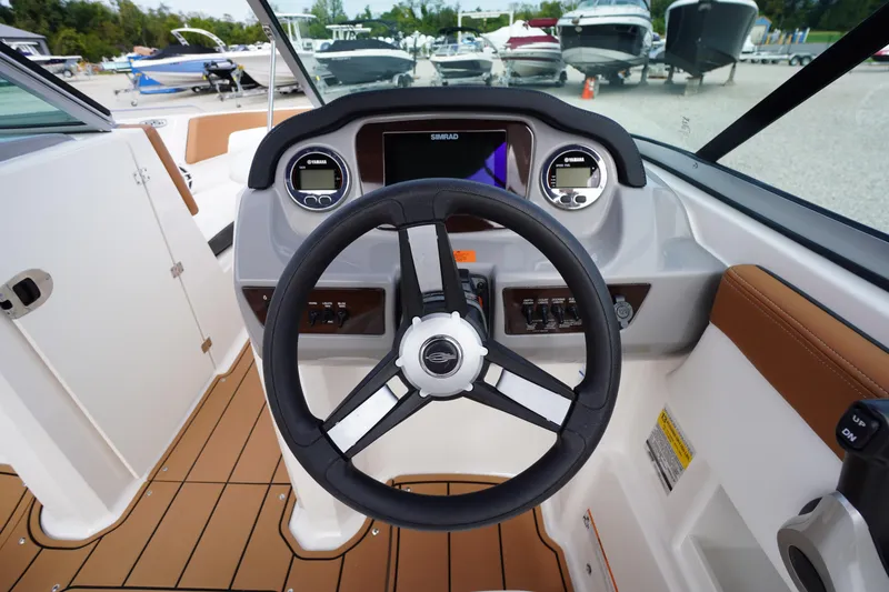 Slide: The Image of 2023 Chaparral 23 SSi OB boat dashboard with steering wheel and controls. - 19