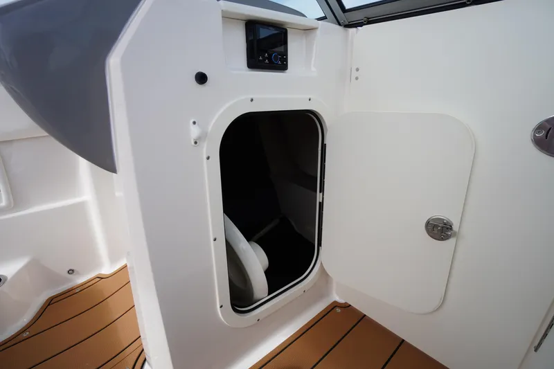 Slide: The Image of 2023 Chaparral 23 SSi OB boat interior with open storage compartment. - 22