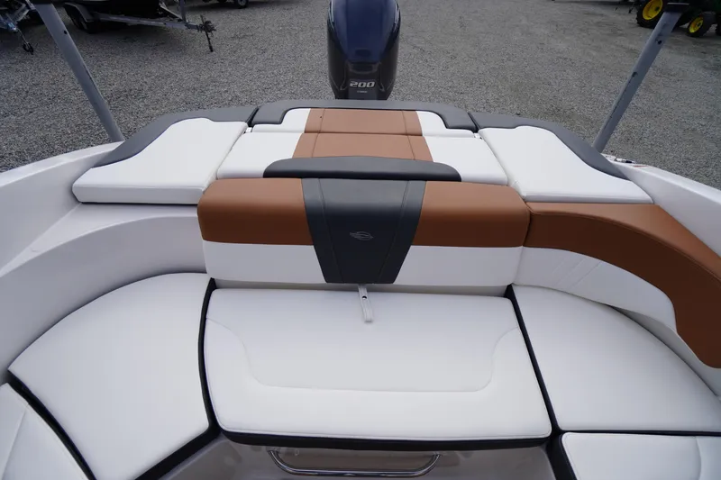 Slide: The Image of 2023 Chaparral 23 SSi OB boat interior with cushioned seating and outboard motor. - 27