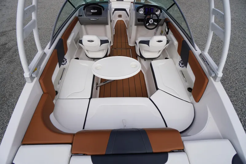 Slide: The Image of 2023 Chaparral 23 SSi OB boat interior with seating, table, and steering console. - 30