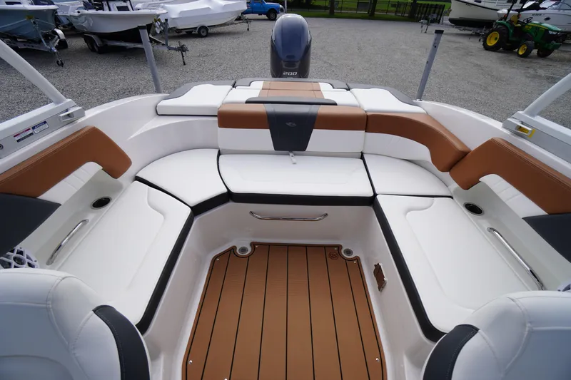 Slide: The Image of 2023 Chaparral 23 SSi OB boat interior with white and brown seating. - 31
