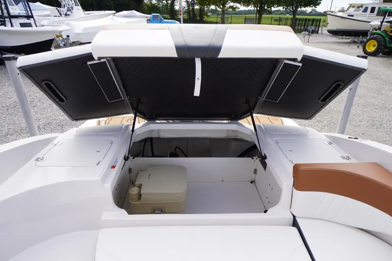 Slide: The Image of 2023 Chaparral 23 SSi OB boat with open storage compartment and seating area. - 34