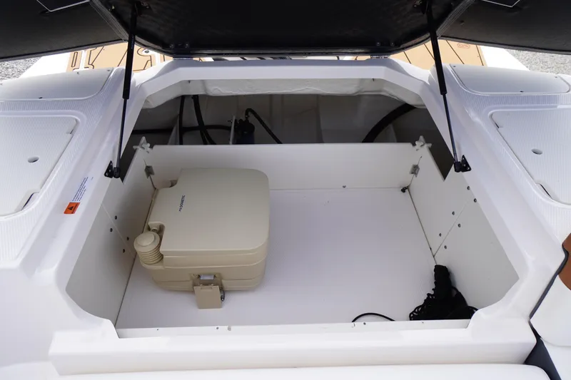 Slide: The Image of 2023 Chaparral 23 SSi OB boat storage compartment with portable toilet. - 35