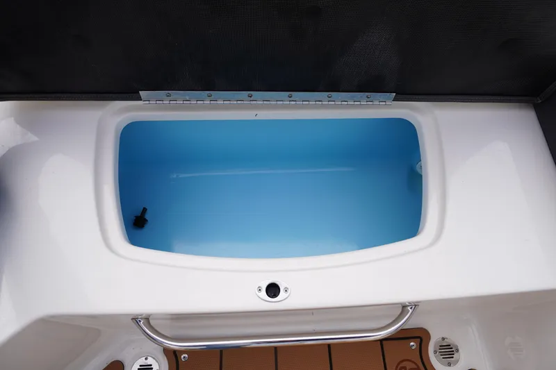 Slide: The Image of 2023 Chaparral 23 SSi OB boat livewell with blue interior and stainless steel handle. - 37