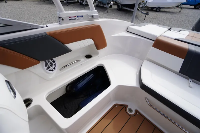 Slide: The Image of 2023 Chaparral 23 SSi OB boat interior with storage and seating area. - 38