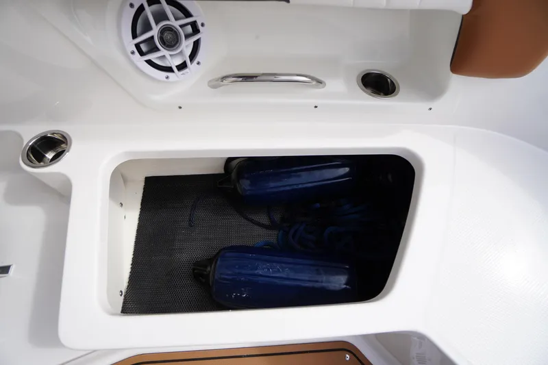 Slide: The Image of Storage compartment on 2023 Chaparral 23 SSi OB boat with speakers and fenders. - 39
