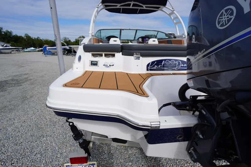 Slide: The Image of 2023 Chaparral 23 SSi OB boat with outboard motor, rear view on gravel lot. - 49