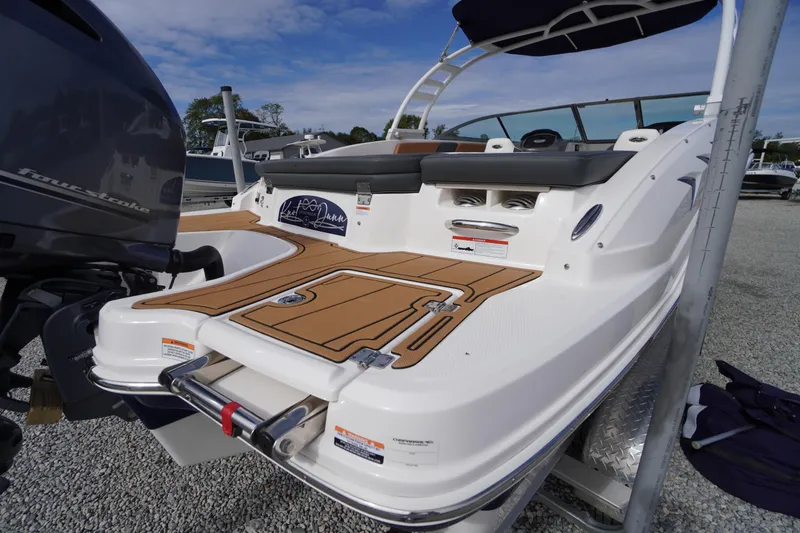 Slide: The Image of 2023 Chaparral 23 SSi OB boat with sleek design and outboard motor. - 51