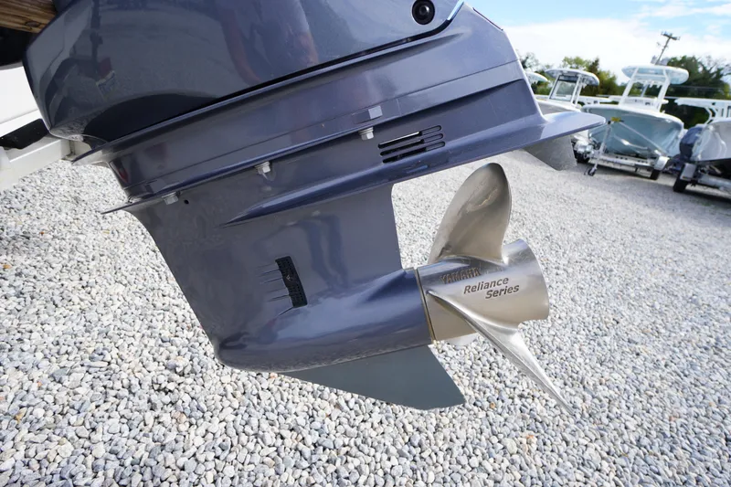 Slide: The Image of 2023 Chaparral 23 SSi OB outboard motor with Reliance Series propeller on gravel. - 55
