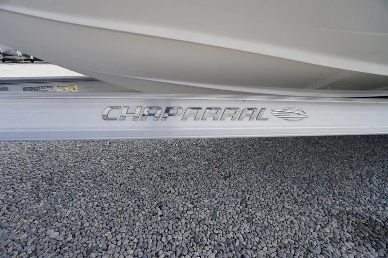 Slide: The Image of 2023 Chaparral 23 SSi OB boat trailer on gravel surface. - 56
