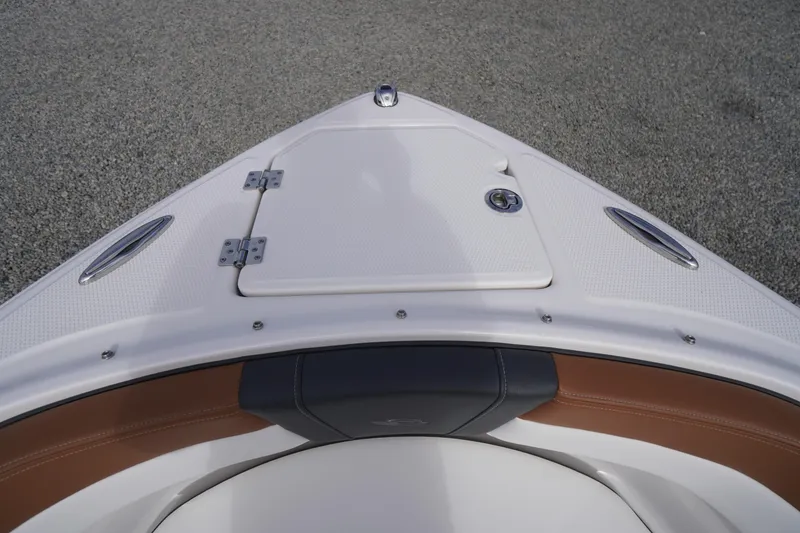 Slide: The Image of 2023 Chaparral 23 SSi OB boat bow with storage compartment and sleek design. - 6