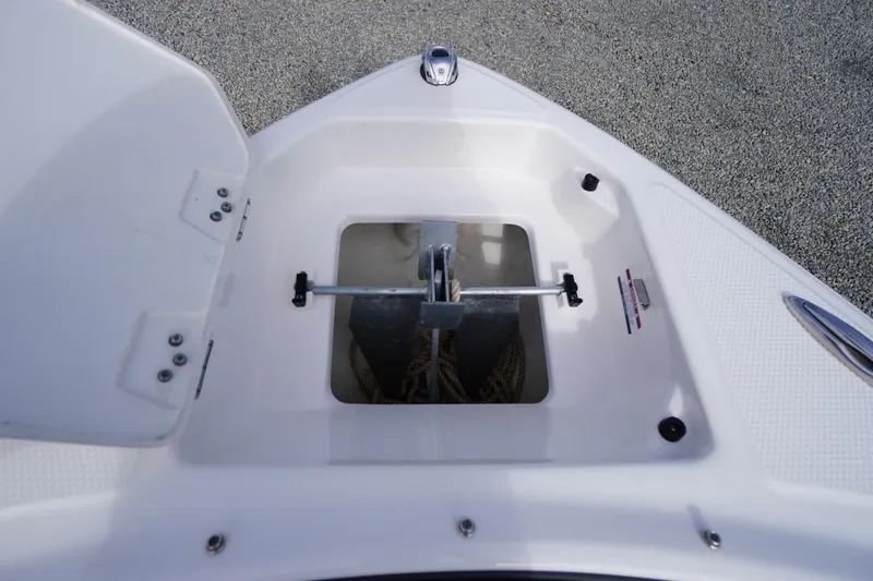 Slide: The Image of 2023 Chaparral 23 SSi OB boat anchor storage compartment with open hatch. - 7