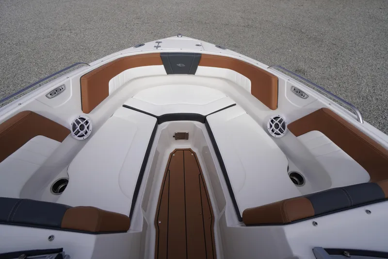 Slide: The Image of 2023 Chaparral 23 SSi OB boat interior with brown and white seating. - 8