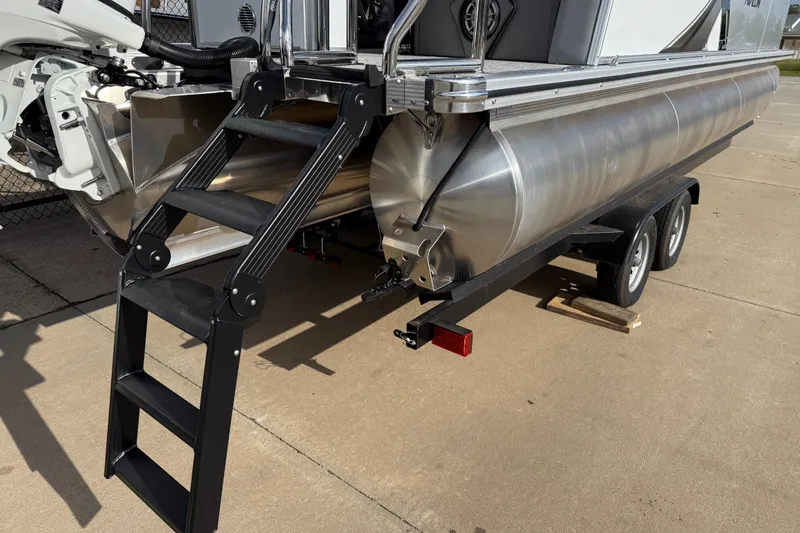 Slide: The Image of 2026 Avalon LSZ Quad Lounger Shift pontoon boat on trailer with ladder. - 10