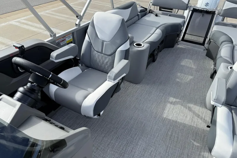 Slide: The Image of 2026 Avalon LSZ Quad Lounger Shift boat interior with gray seating and steering wheel. - 17