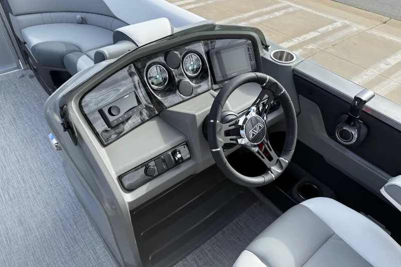 Slide: The Image of 2026 Avalon LSZ Quad Lounger Shift boat dashboard with steering wheel and controls. - 19