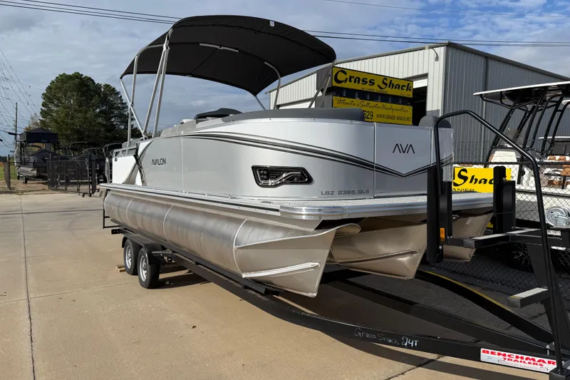 Slide: The Image of 2026 Avalon LSZ QUAD LOUNGER SHIFT pontoon boat on trailer, outdoor display. - 3