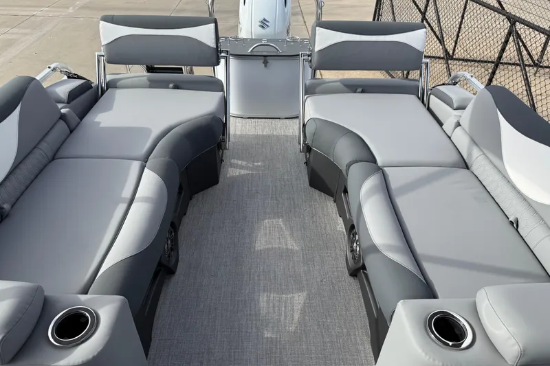 Slide: The Image of 2026 Avalon LSZ Quad Lounger Shift boat interior with gray seating and cup holders. - 32