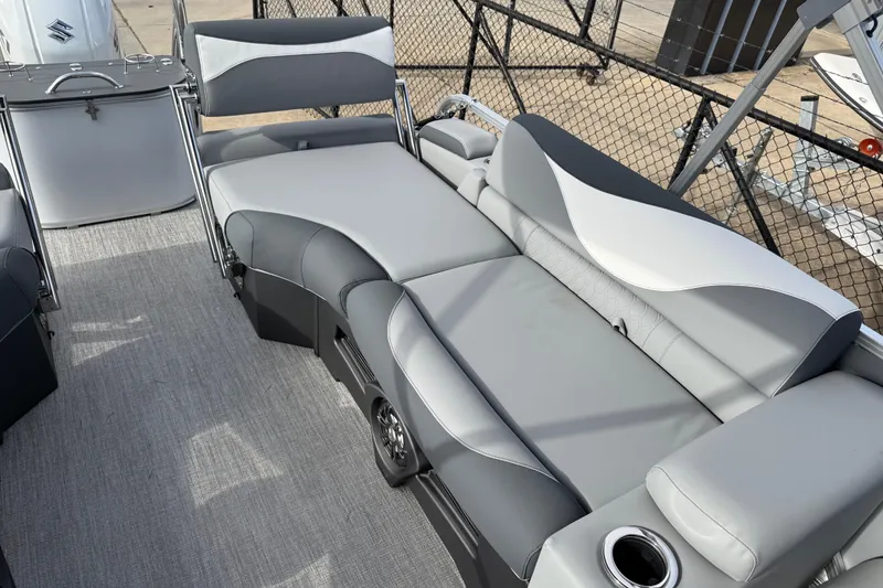 Slide: The Image of 2026 Avalon LSZ Quad Lounger Shift boat interior with gray seating and cup holder. - 34