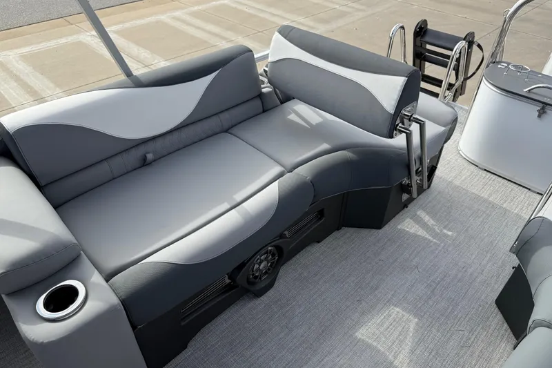 Slide: The Image of 2026 Avalon LSZ Quad Lounger Shift boat interior with gray seating and cup holder. - 35