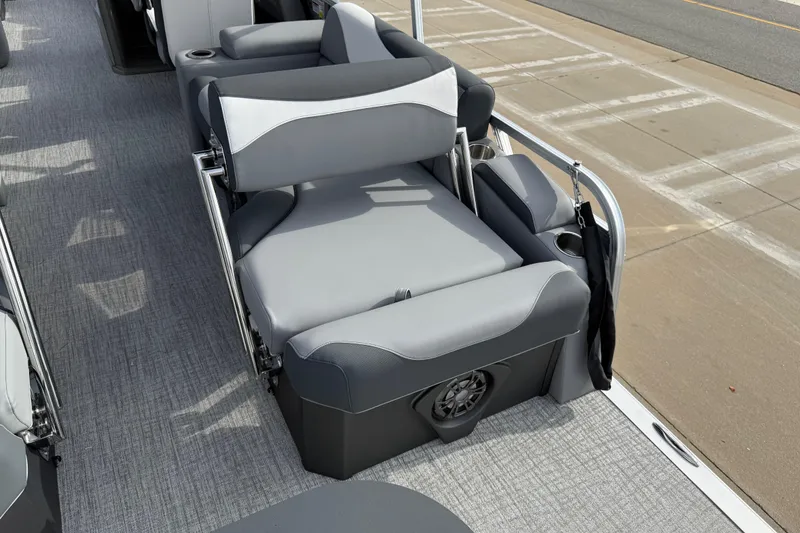 Slide: The Image of 2026 Avalon LSZ Quad Lounger Shift boat interior with gray seating and cup holders. - 38