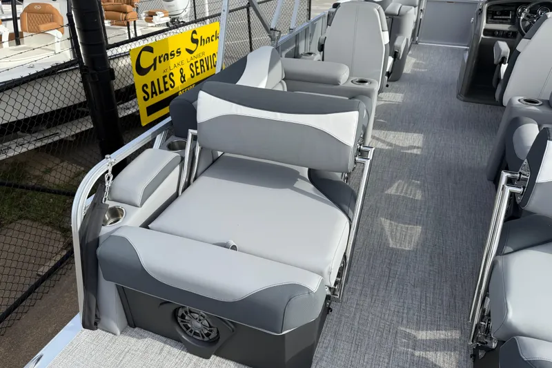 Slide: The Image of 2026 Avalon LSZ Quad Lounger Shift boat interior with gray seating and cup holders. - 39