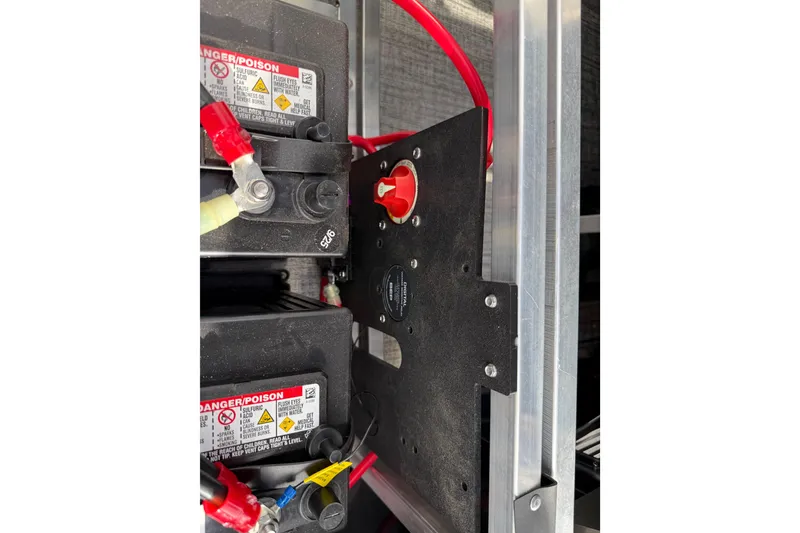 Slide: The Image of Battery compartment of 2026 Avalon LSZ Quad Lounger Shift with red cables and warning labels. - 46