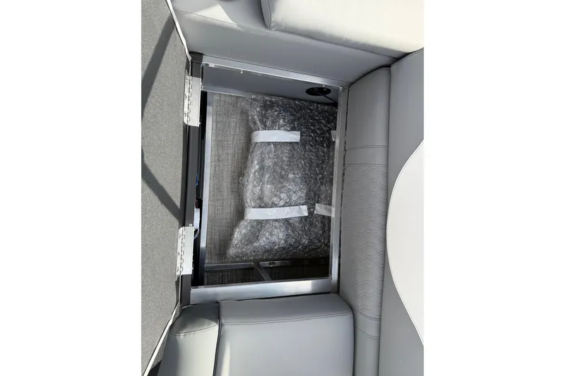 Slide: The Image of 2026 Avalon LSZ Quad Lounger Shift storage compartment with bubble wrap packaging. - 47