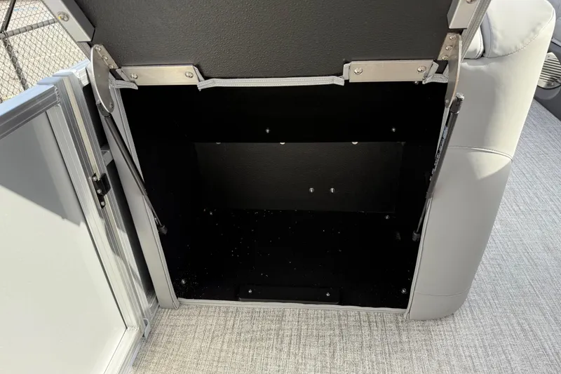 Slide: The Image of Open storage compartment in 2026 Avalon LSZ Quad Lounger Shift boat. - 48