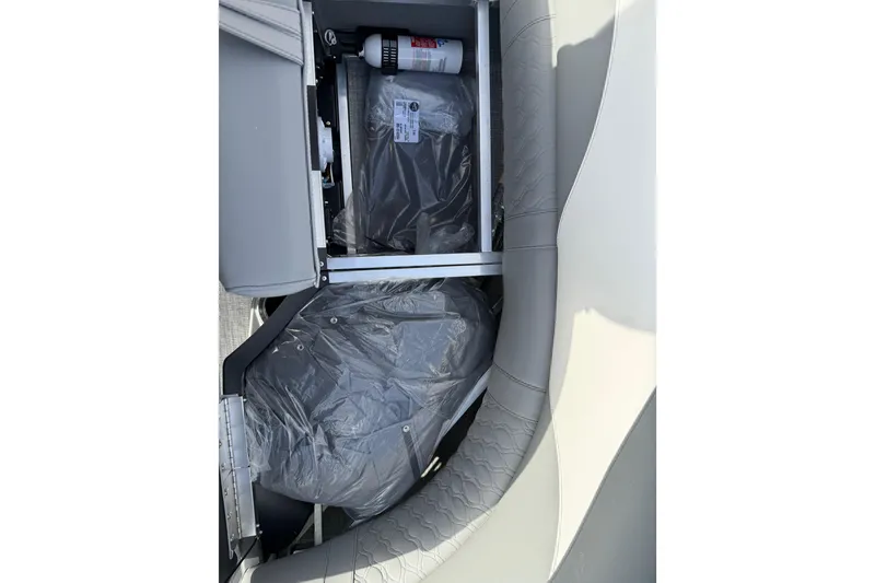 Slide: The Image of 2026 Avalon LSZ Quad Lounger Shift storage compartment with fire extinguisher and protective covers. - 49