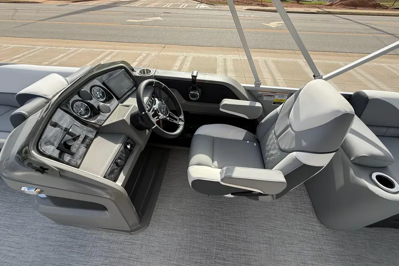 Slide: The Image of 2026 Avalon LSZ Quad Lounger Shift boat interior with modern dashboard and comfortable seating. - 52