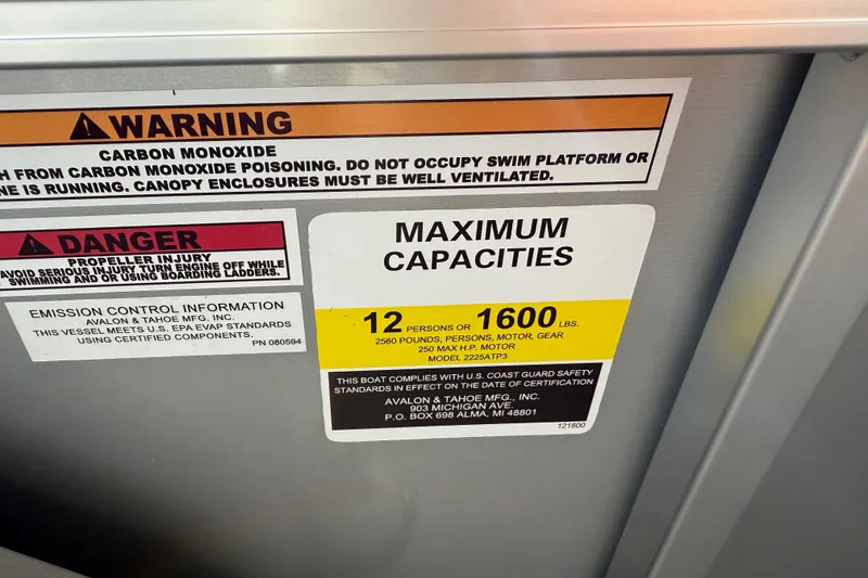 Slide: The Image of Warning and capacity labels on 2026 Avalon LSZ Quad Lounger Shift boat. - 53